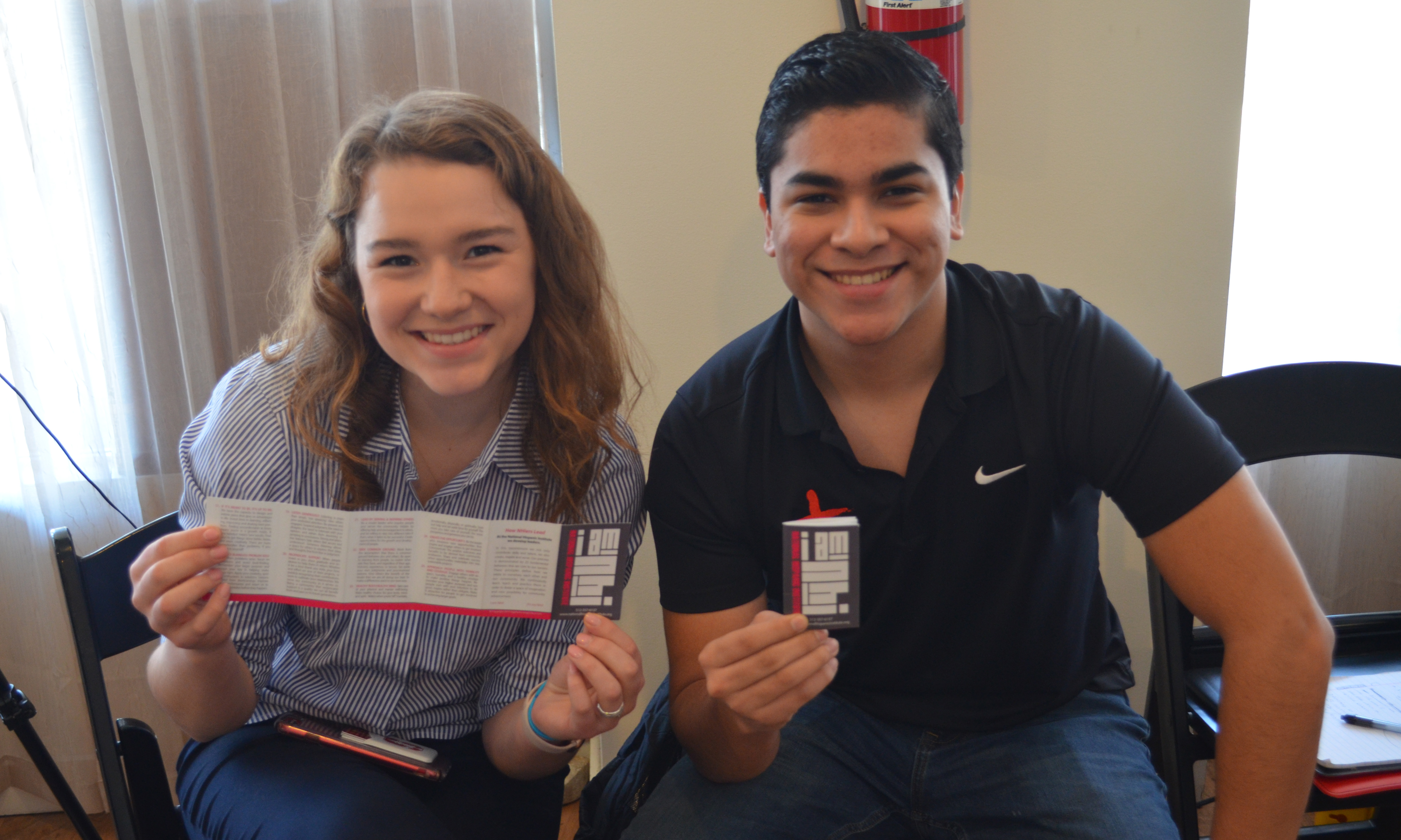 Two NHIers at 2019 PA training, showing off the new NHI Foundations cards