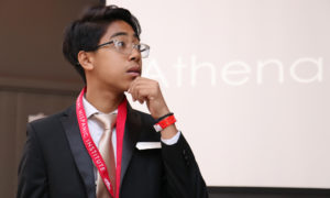 Great Debate student in front of presentation screen