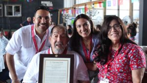 Carlos Paz, Ernesto Nieto, Rep. Alexandria Ocasio-Cortez, and Gloria de Leon with Congressional Record proclamation for Nieto