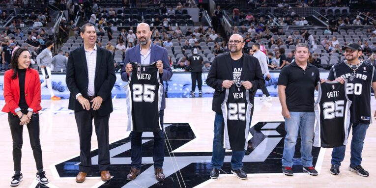 roy and chris nieto receiving an award from the san antonio spurs for nhi and ernesto nieto