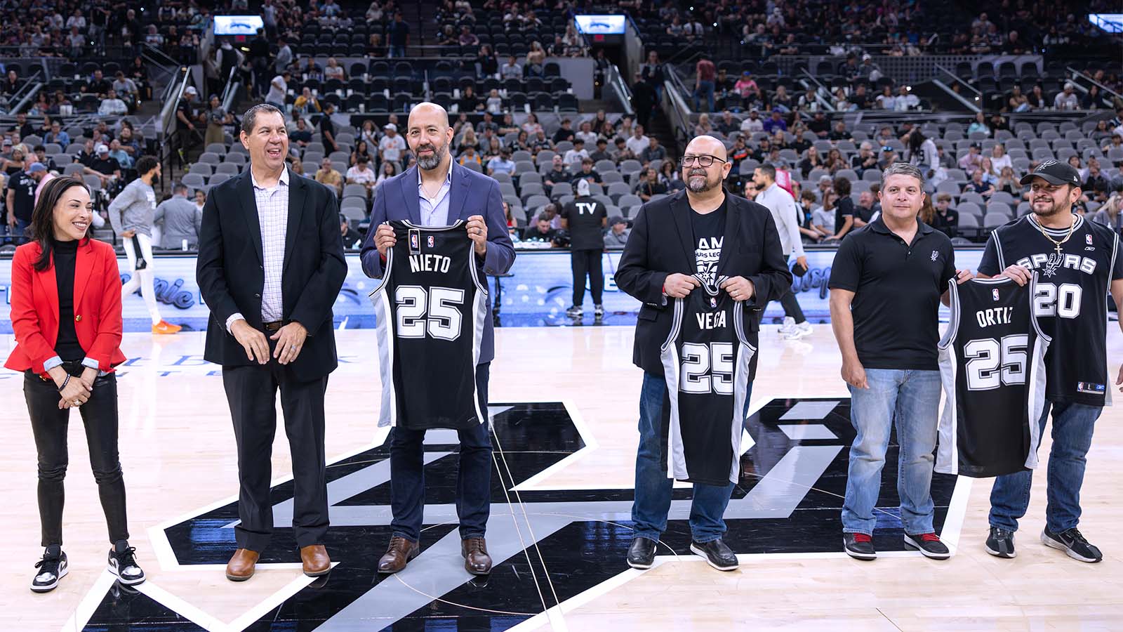 roy and chris nieto receiving an award from the san antonio spurs for nhi and ernesto nieto