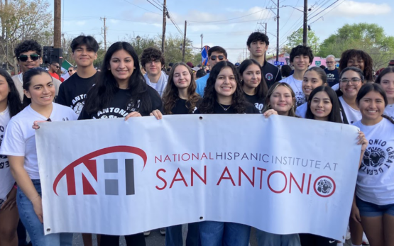 Group of NHI@SA students holding banner